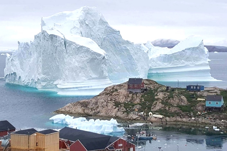Гигантский айсберг навис над деревней в Гренландии